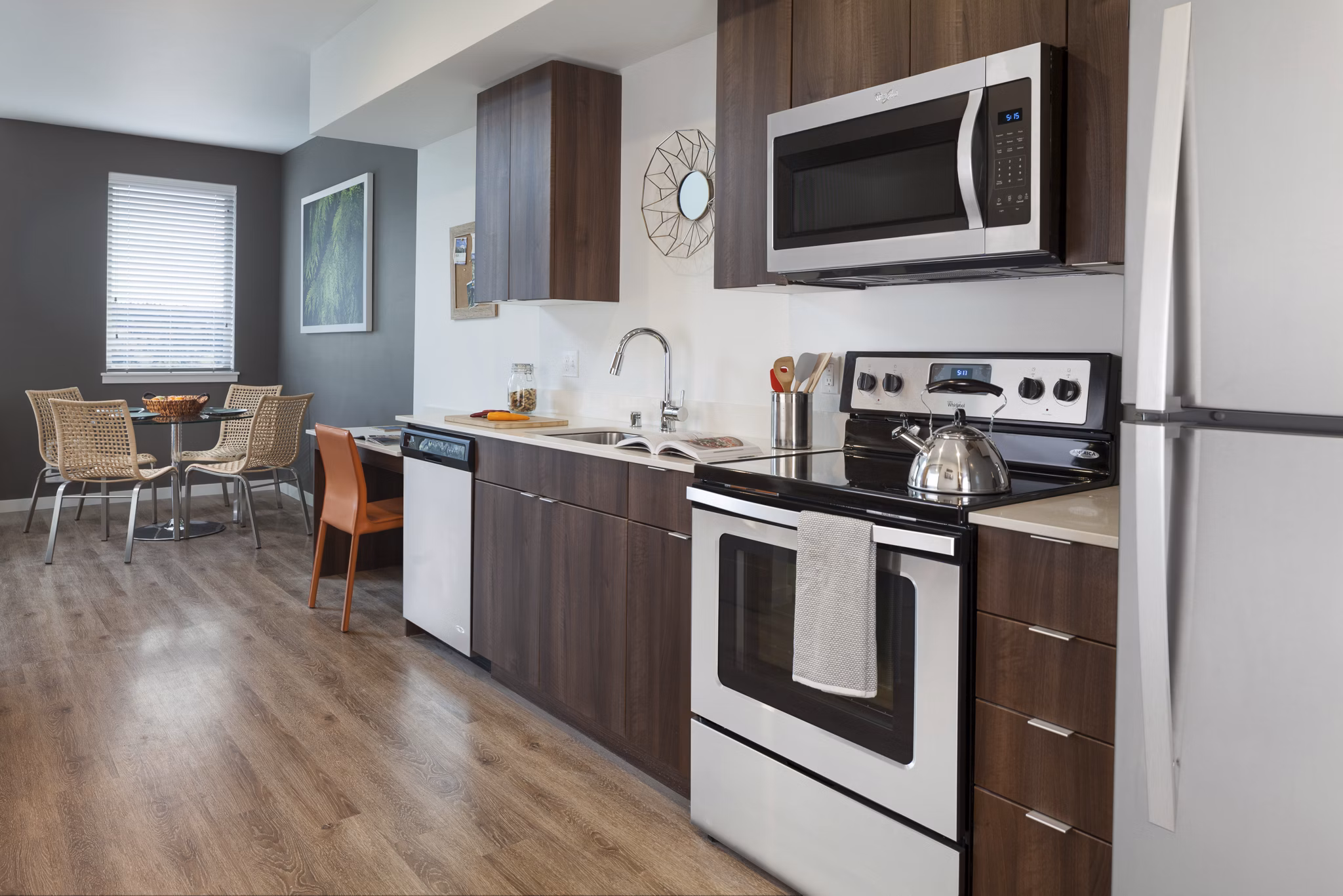 Modern kitchen with sleek cabinetry and stainless steel appliances at Spencer 68 Apartments