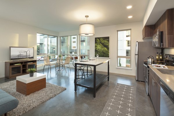 Modern kitchen with stainless steel appliances and sleek cabinetry in Spencer 68 Apartments