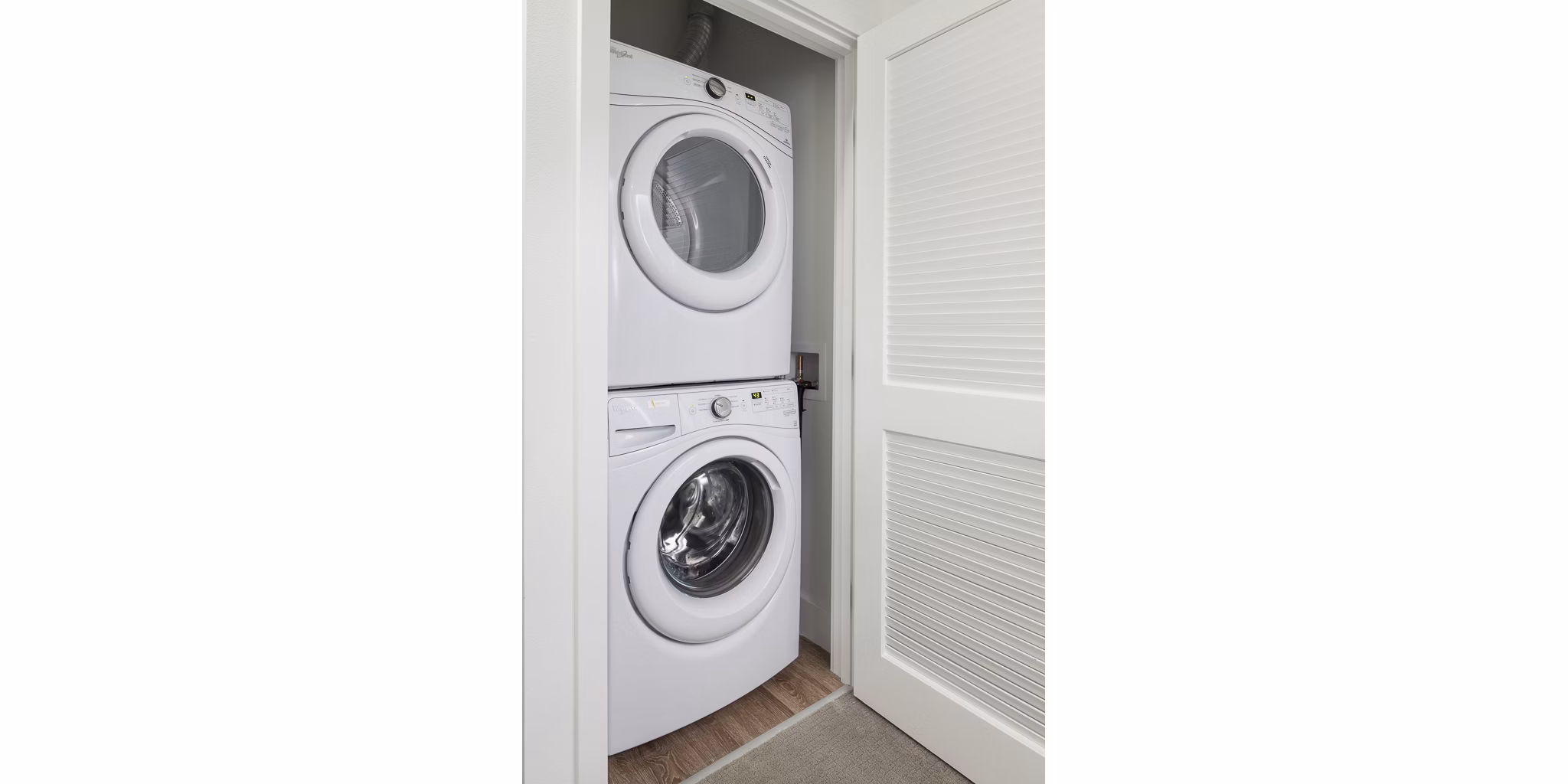Modern laundry room with high-efficiency washers and dryers at Spencer 68 Apartments