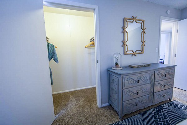 Modern bedroom with stylish decor and large windows at The Mica Apartments, perfect for a luxurious living experience
