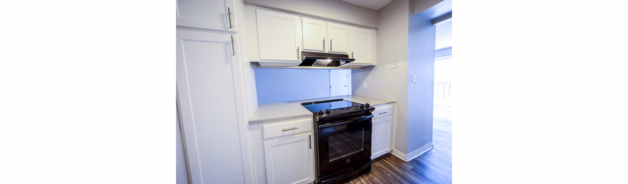 The Mica Apartments: Modern kitchen with sleek countertops and stainless steel appliances
