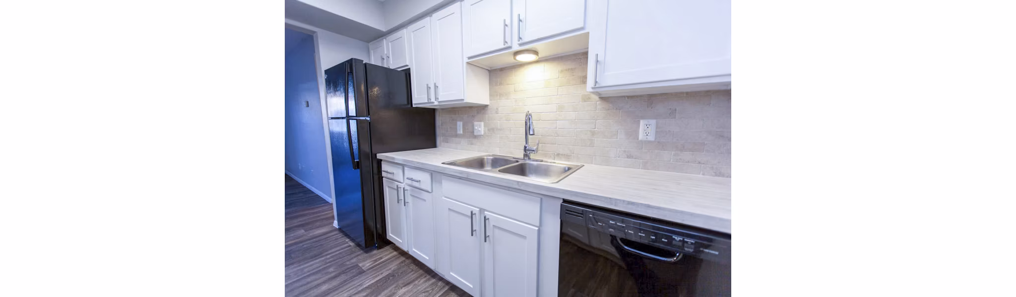 Modern kitchen with stainless appliances at The Mica Apartments, San Francisco - luxury living in a Greystar community