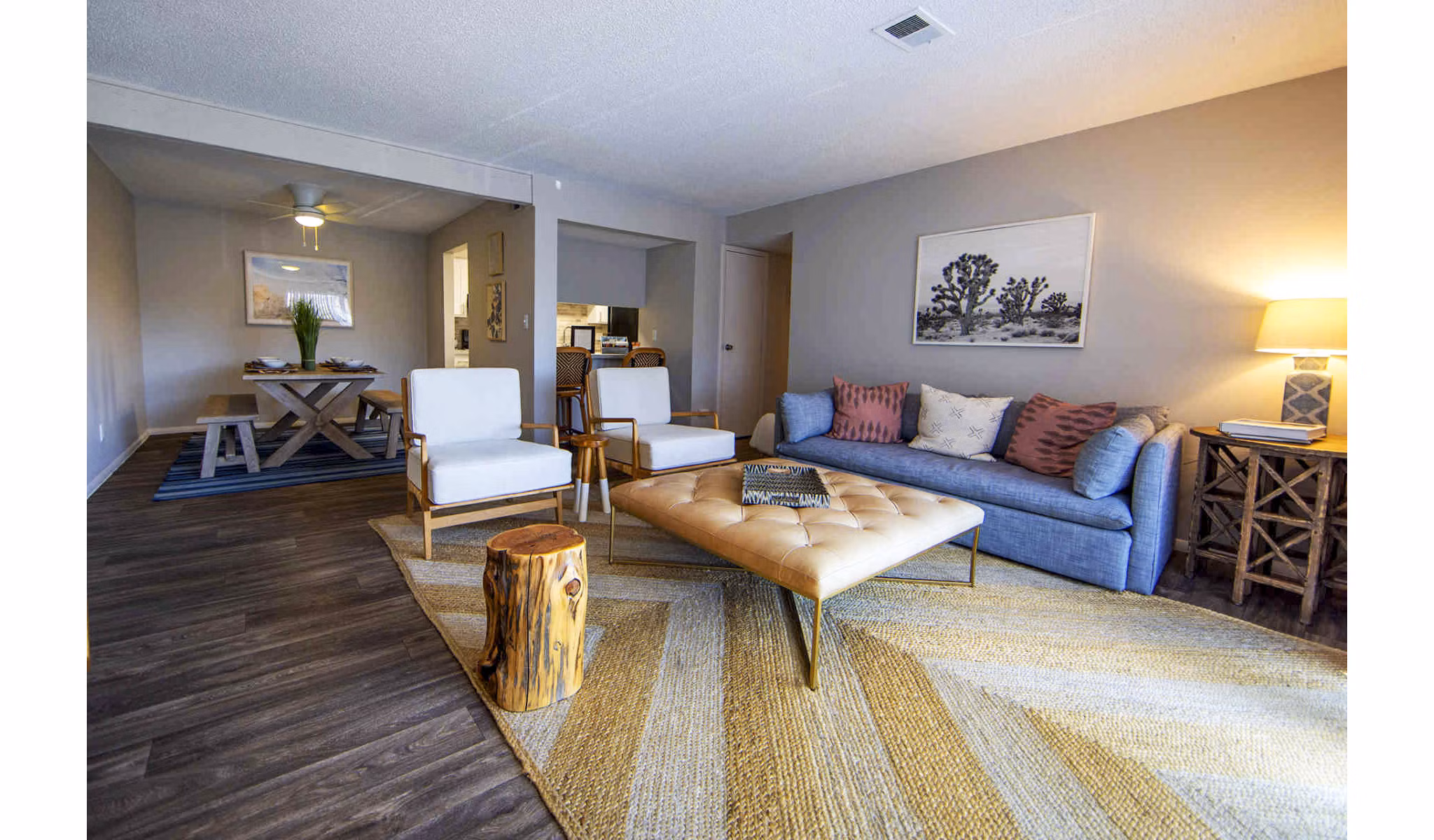 Cozy living room with modern decor and large windows in The Mica Apartments