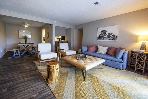 Cozy living room with modern decor and large windows in The Mica Apartments