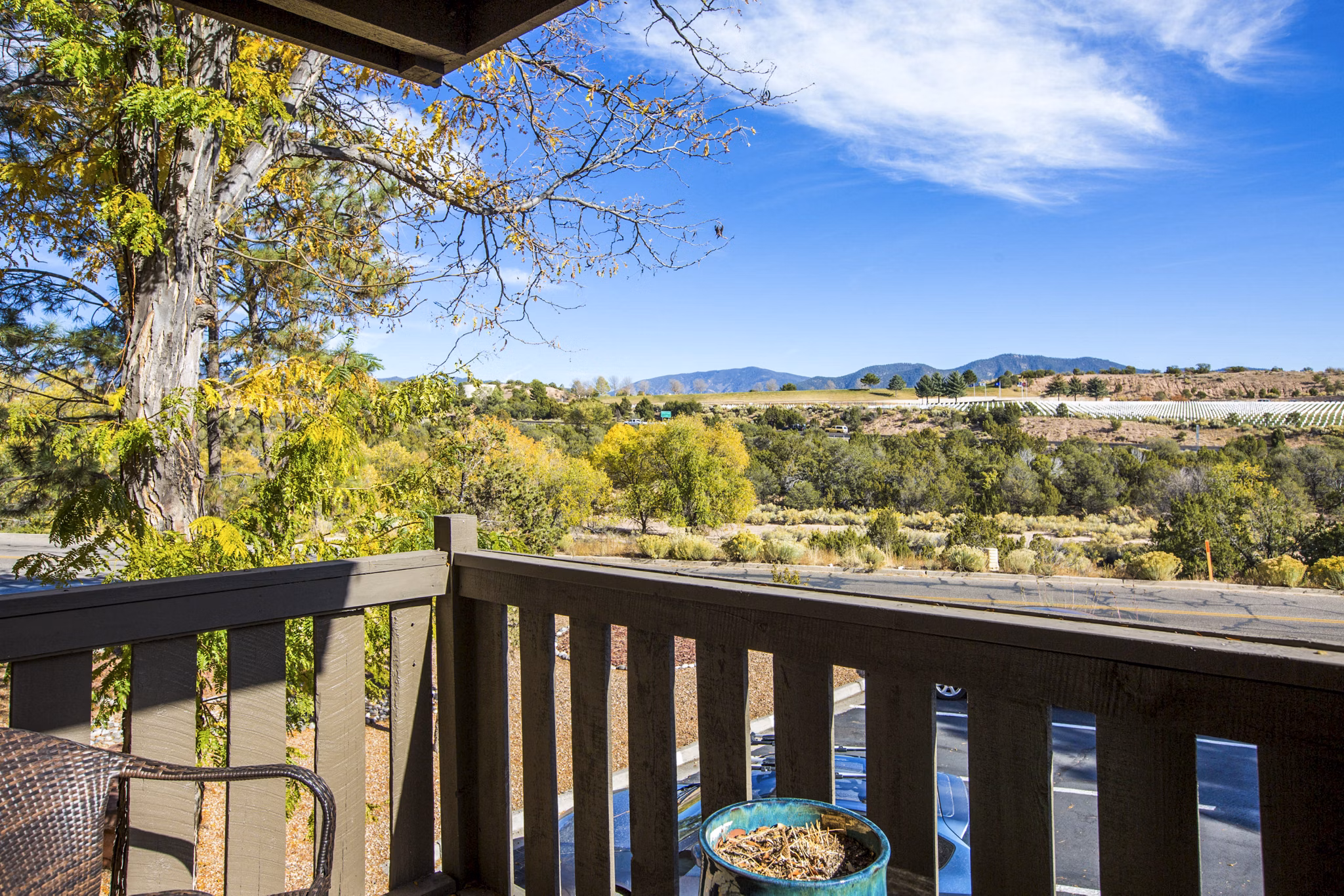 Private patio with stylish outdoor seating at The Mica Apartments, offering luxury living spaces for relaxation and views