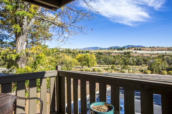 Private patio with stylish outdoor seating at The Mica Apartments, offering luxury living spaces for relaxation and views