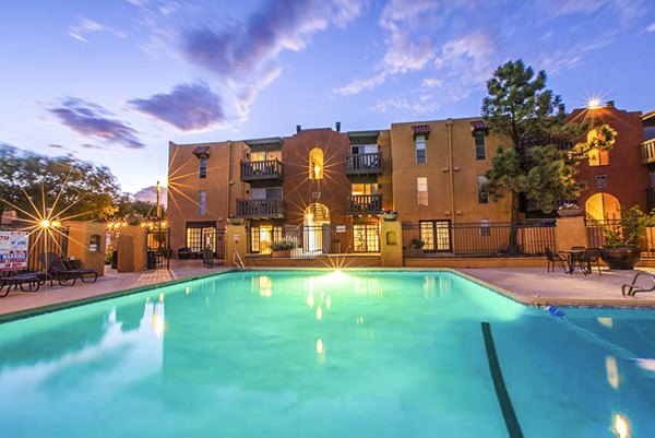 Outdoor swimming pool with lounge area at The Mica Apartments, providing luxury amenities and relaxation for residents