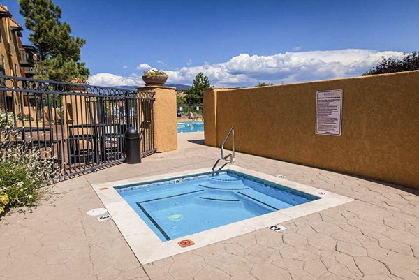 Hot tub oasis at The Mica Apartments with bubbling jets and lush surroundings, perfect for relaxation and leisure