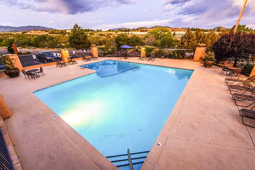 Modern swimming pool with sun loungers at The Mica Apartments, offering luxury living near downtown attractions and amenities