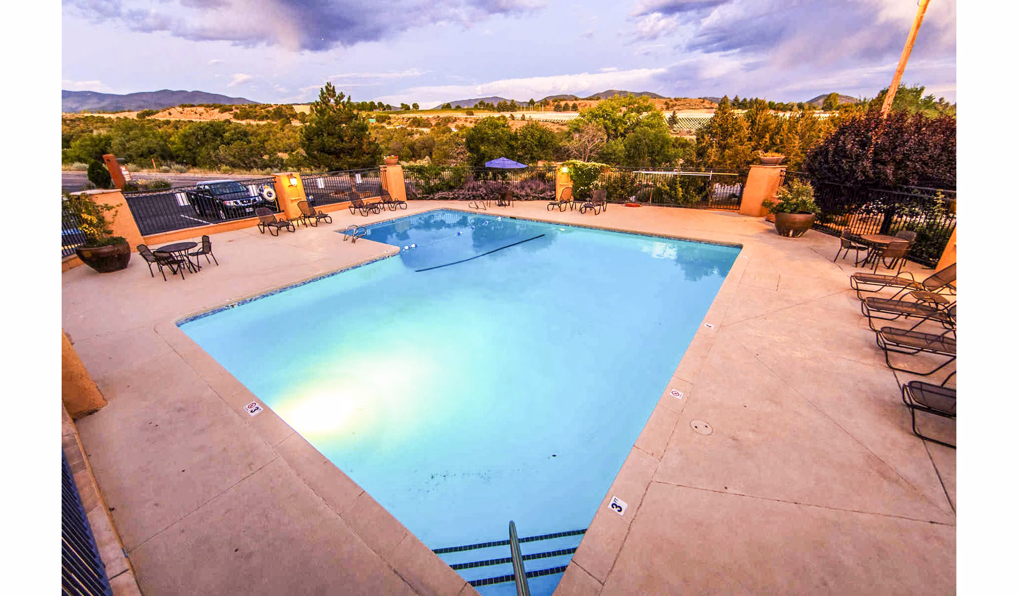 Modern swimming pool with sun loungers at The Mica Apartments, offering luxury living near downtown attractions and amenities