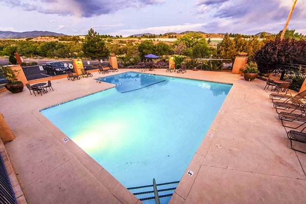 Modern swimming pool with sun loungers at The Mica Apartments, offering luxury living near downtown attractions and amenities