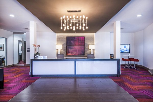 Modern lobby with contemporary design in Atmark Apartments, featuring spacious seating and elegant lighting, perfect for social gatherings