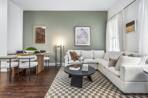 Dining and living room featuring elegant decor and open layout at Atmark Apartments