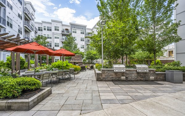 Outdoor grilling area with modern BBQ stations at Atmark Apartments, ideal for social gatherings and relaxation