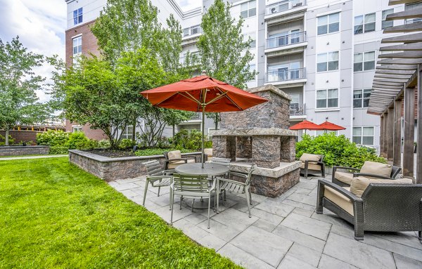 Outdoor gathering area with modern fire pit at Atmark Apartments, luxury living in Cambridge