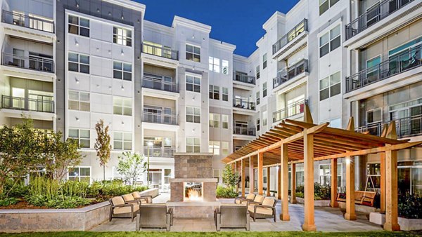 Cozy fire pit on patio at Atmark Apartments, perfect for socializing and relaxing in a Greystar community