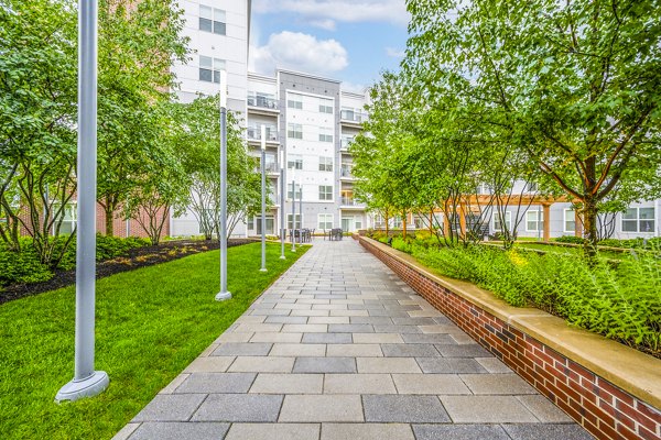 Courtyard with modern seating at Atmark Apartments: Relaxing outdoor space in Cambridge's luxury community