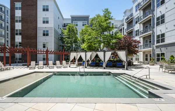 Sun-drenched outdoor pool at Atmark Apartments, offering relaxation and leisure for residents of our luxury community