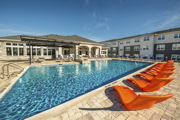 Modern outdoor pool at Prose Magnolia Apartments offering luxury relaxation with stylish seating and landscaping