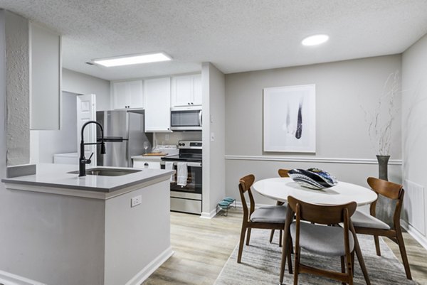 Dining area featuring modern furnishings and natural light at Avana Copper Spring Apartments