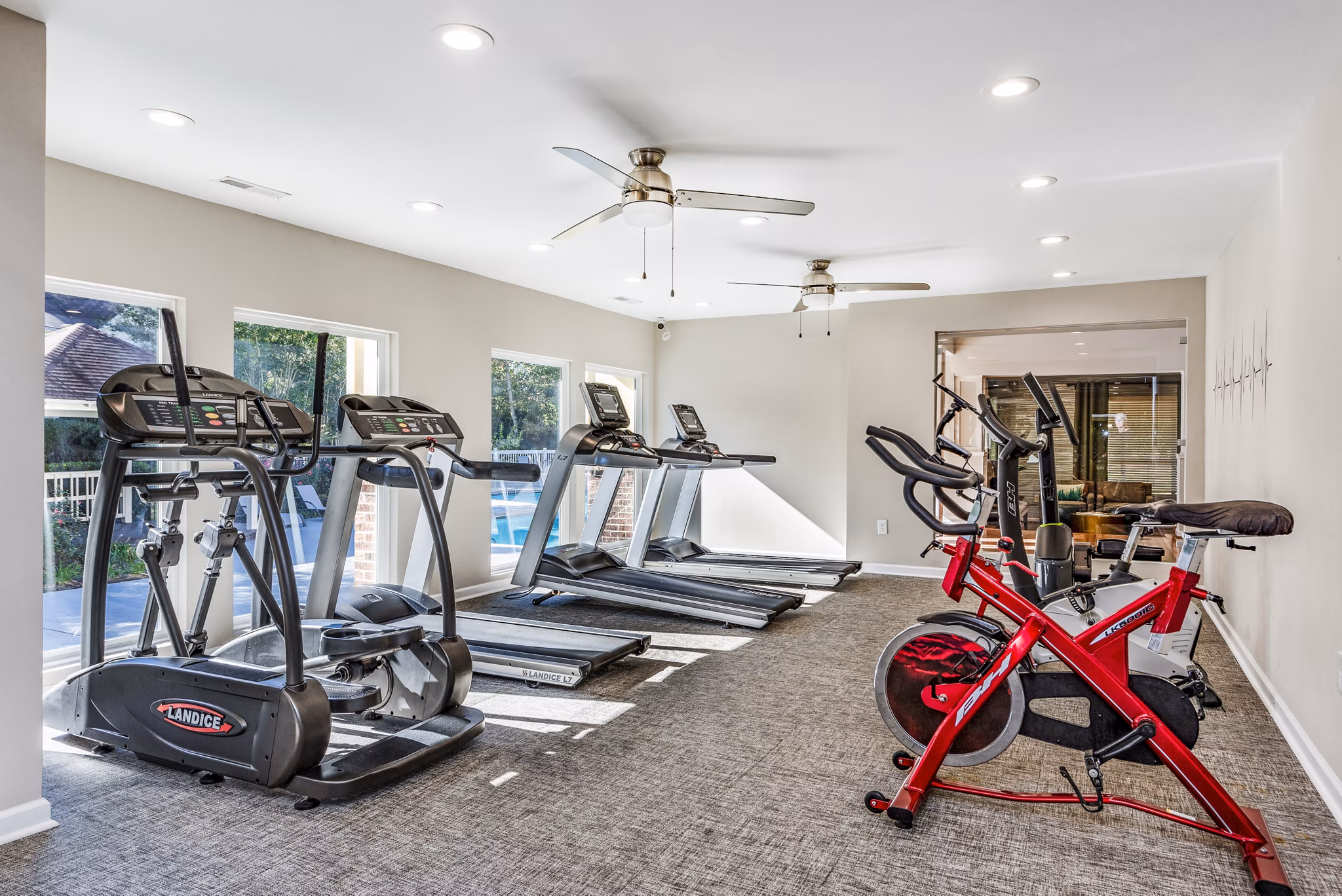 Fitness center with treadmills and stationary bikes in luxury apartment community