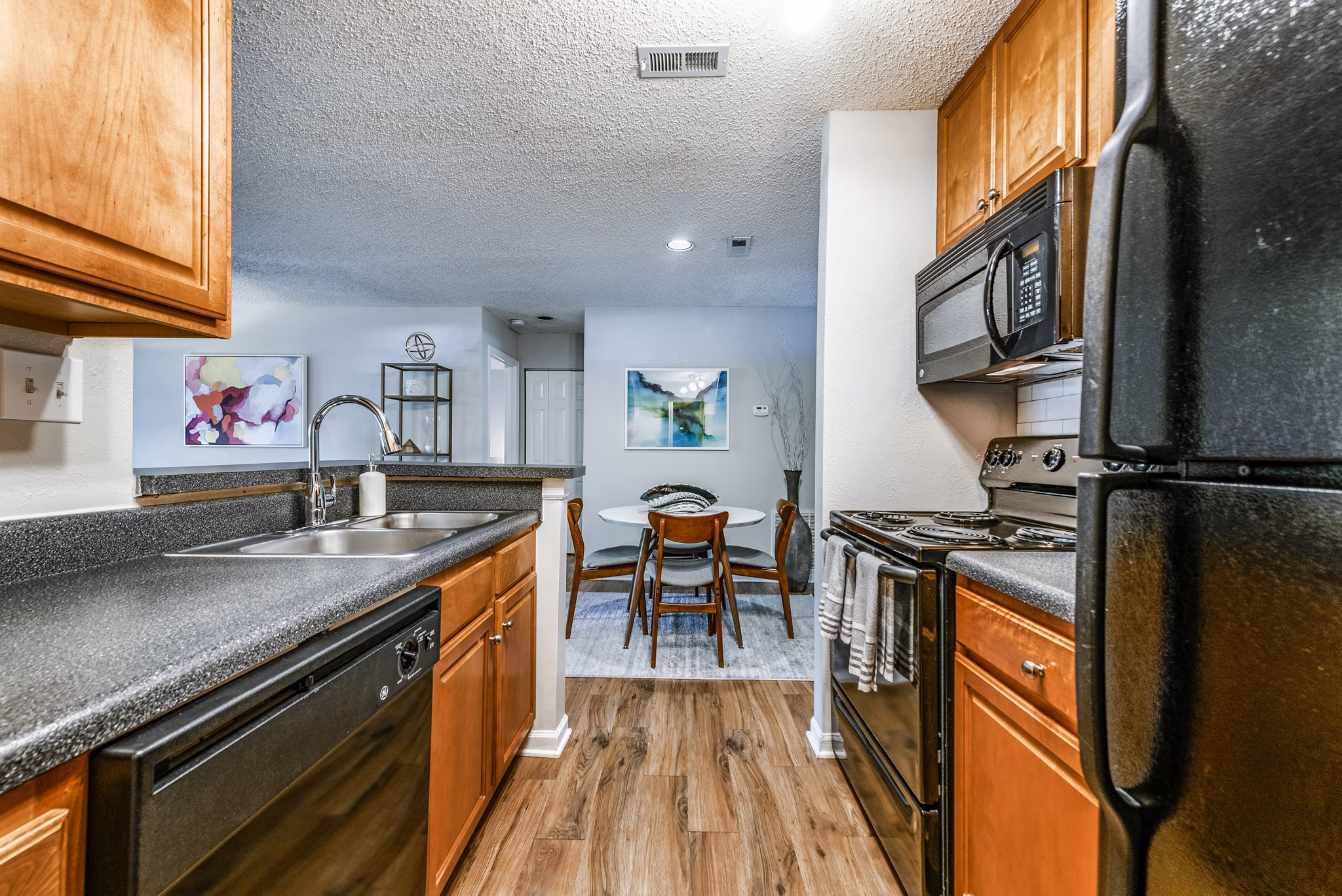 Modern kitchen with stainless steel appliances in Avana Copper Springs apartments