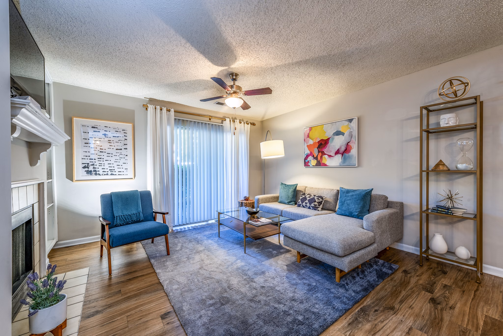 Modern living room with sectional sofa and blue armchair in luxury apartment