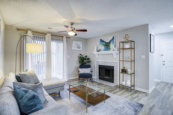 Cozy living room with modern dÃ©cor and large windows at Avana Copper Spring Apartments