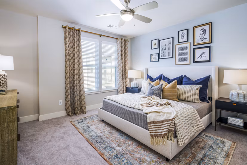 Cozy bedroom with stylish decor in Album Indian Lake Apartments, featuring modern furniture and soft lighting for a relaxing ambiance