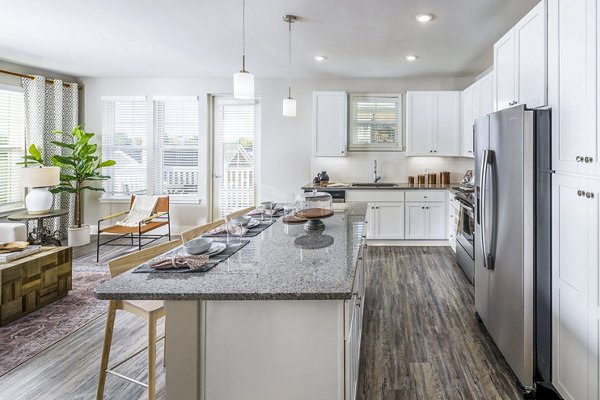 Modern kitchen with stainless steel appliances at Album Indian Lake Apartments