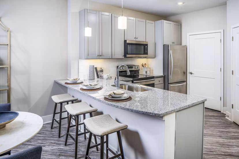Modern kitchen with granite countertops at Album Indian Lake Apartments