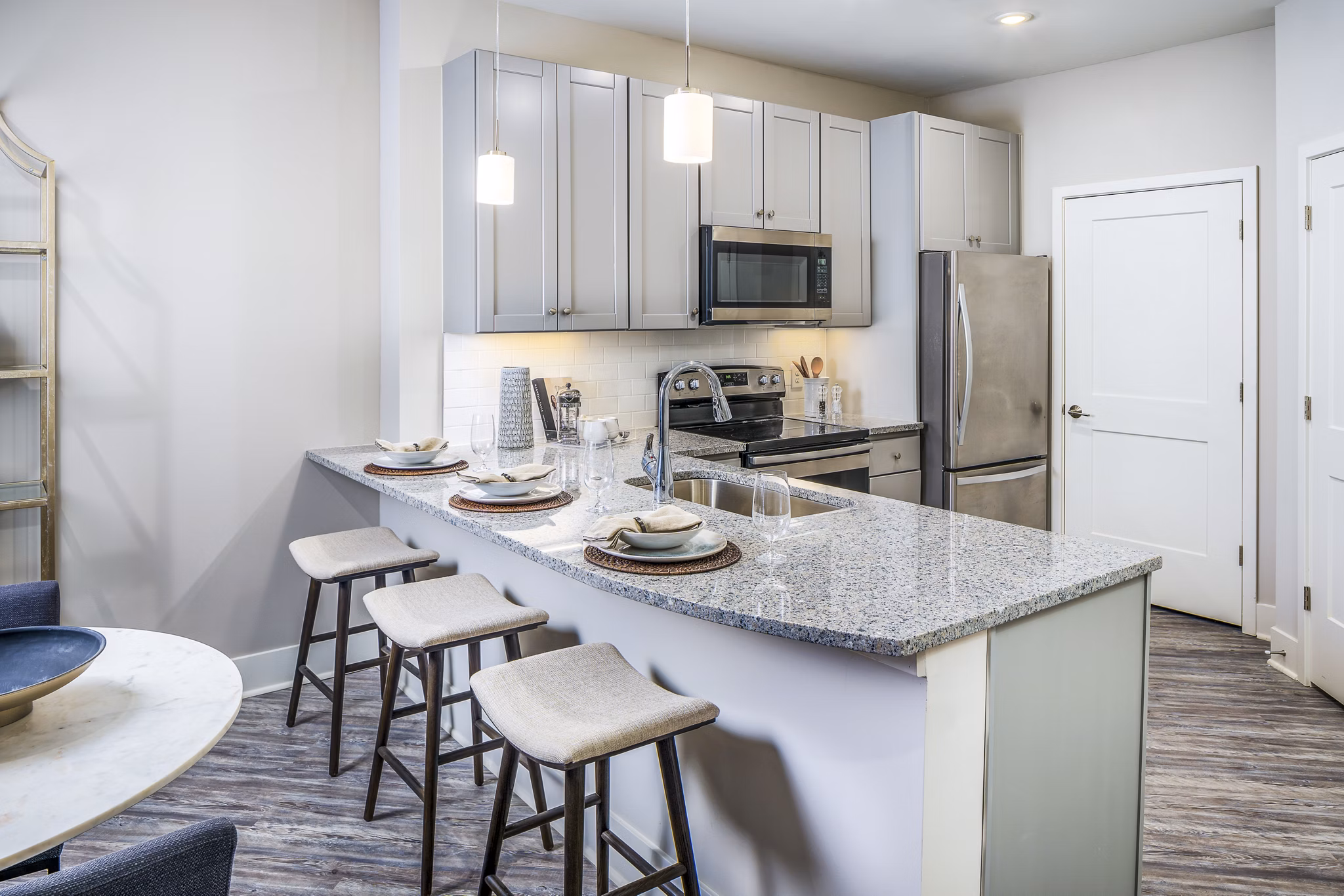 Modern kitchen with granite countertops at Album Indian Lake Apartments
