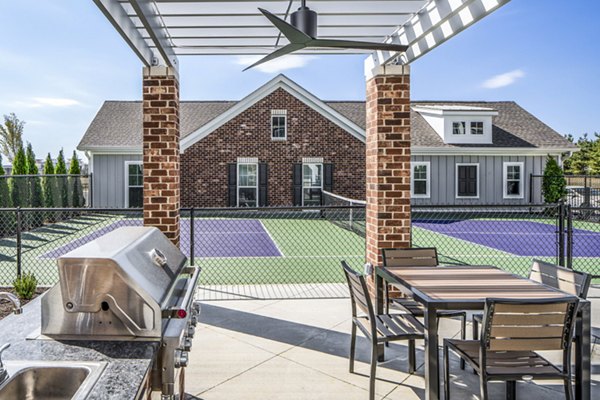 Outdoor grill area at Album Indian Lake Apartments featuring modern amenities for social gatherings and dining