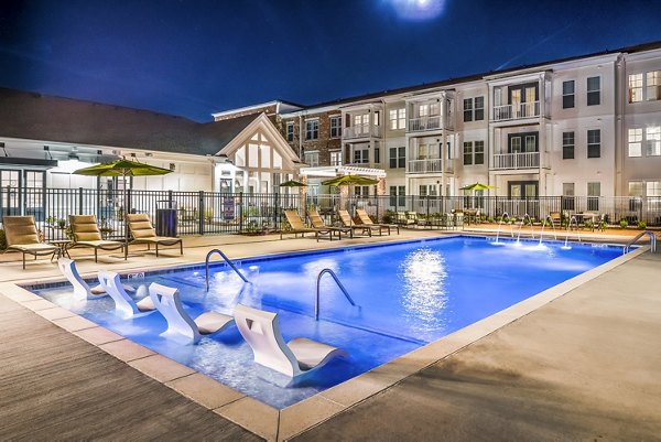 Resort-style pool with loungers at Album Indian Lake Apartments