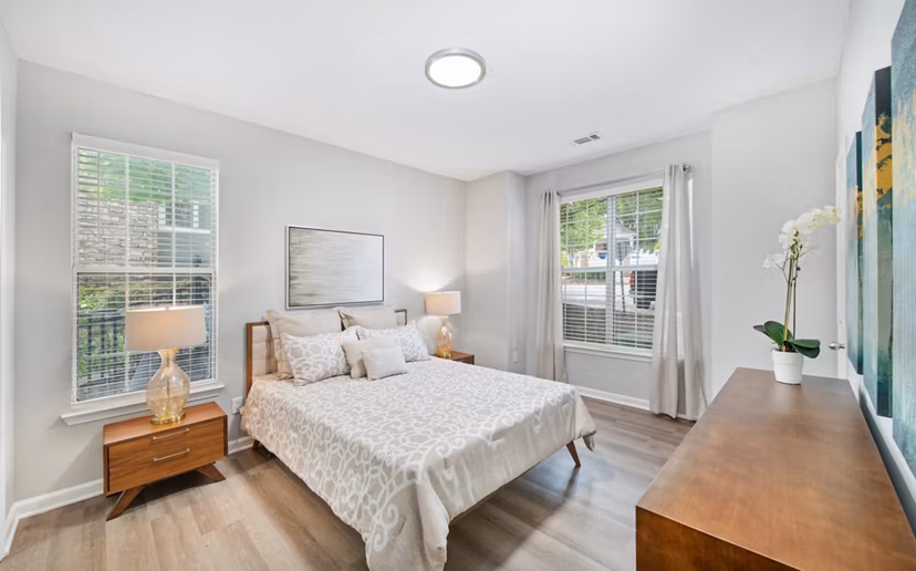 Cozy bedroom with elegant decor and ample lighting at Avana Thornblade Apartments: Luxury living by Greystar in a serene environment