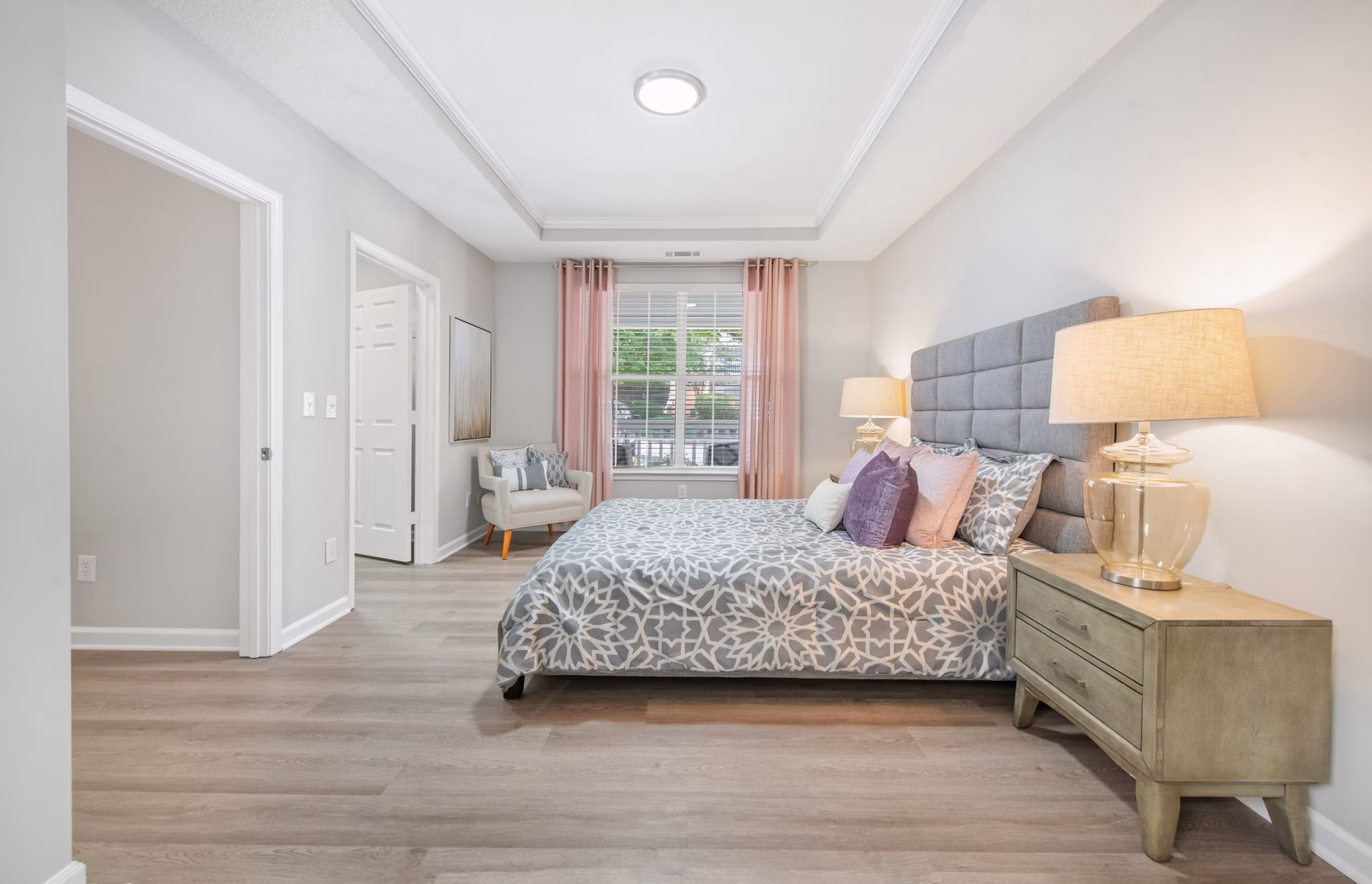 Elegant bedroom with plush bedding and modern decor at Avana Thornblade Apartments