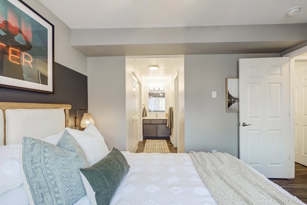 Bedroom with modern decor and natural light at Habitat apartments in Fort Collins