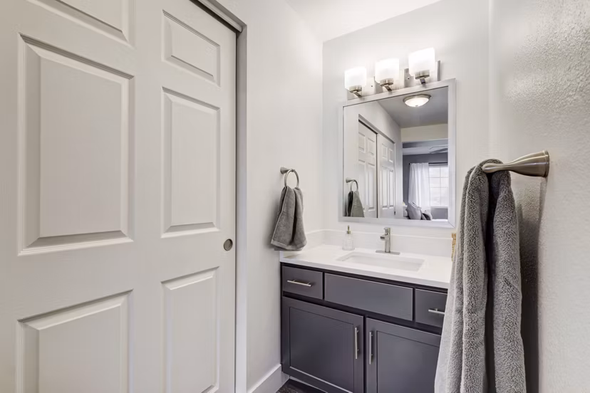 Bathroom with sleek fixtures and modern vanity in Habitat at Fort Collins luxury apartments