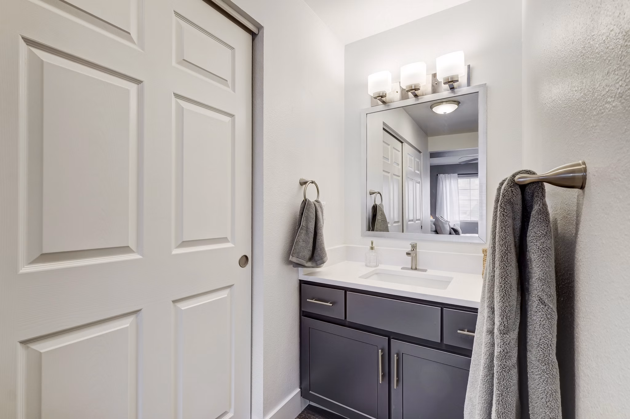 Bathroom with sleek fixtures and modern vanity in Habitat at Fort Collins luxury apartments