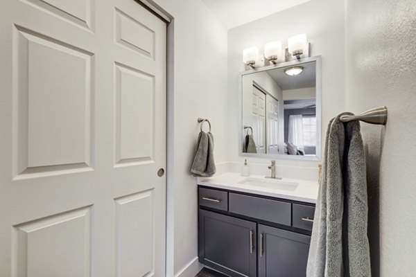 Bathroom with sleek fixtures and modern vanity in Habitat at Fort Collins luxury apartments
