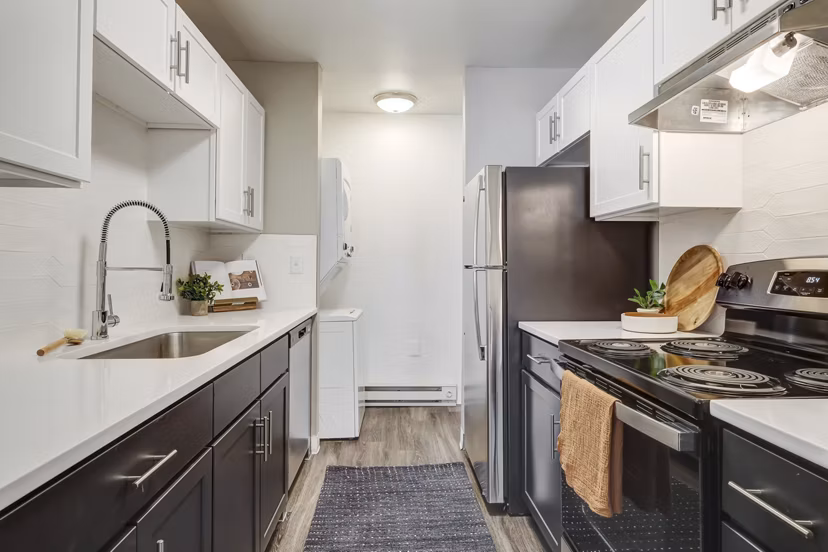 Modern kitchen with stainless steel appliances at Habitat at Fort Collins luxury apartments