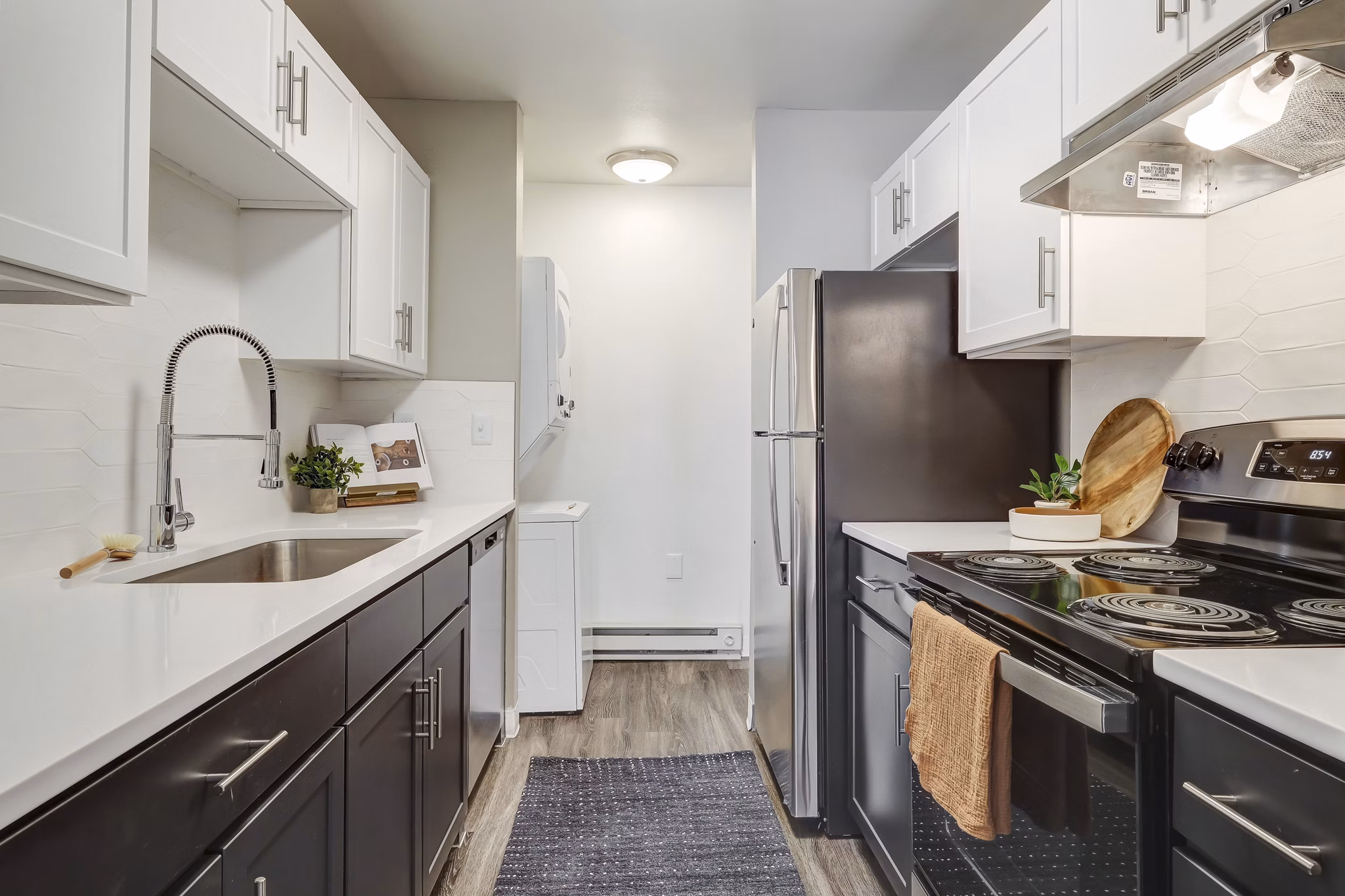 Modern kitchen with stainless steel appliances at Habitat at Fort Collins luxury apartments