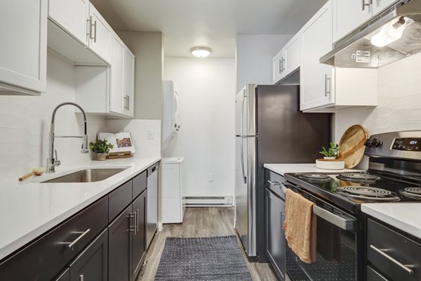Modern kitchen with stainless steel appliances at Habitat at Fort Collins luxury apartments