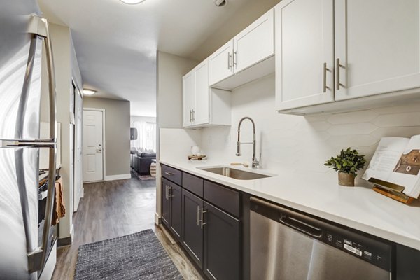 Kitchen showcasing modern appliances and stylish cabinetry at Habitat at Fort Collins apartments in Colorado