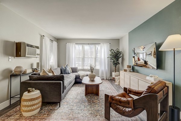 Cozy living room featuring modern furnishings and large windows in Habitat at Fort Collins apartments