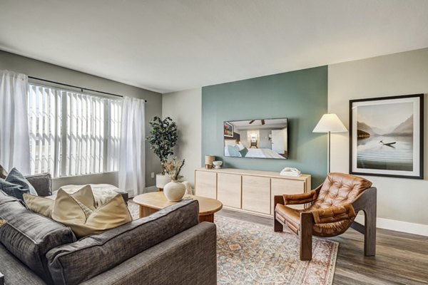 Living room featuring modern furnishings and large windows in Habitat at Fort Collins luxury apartments