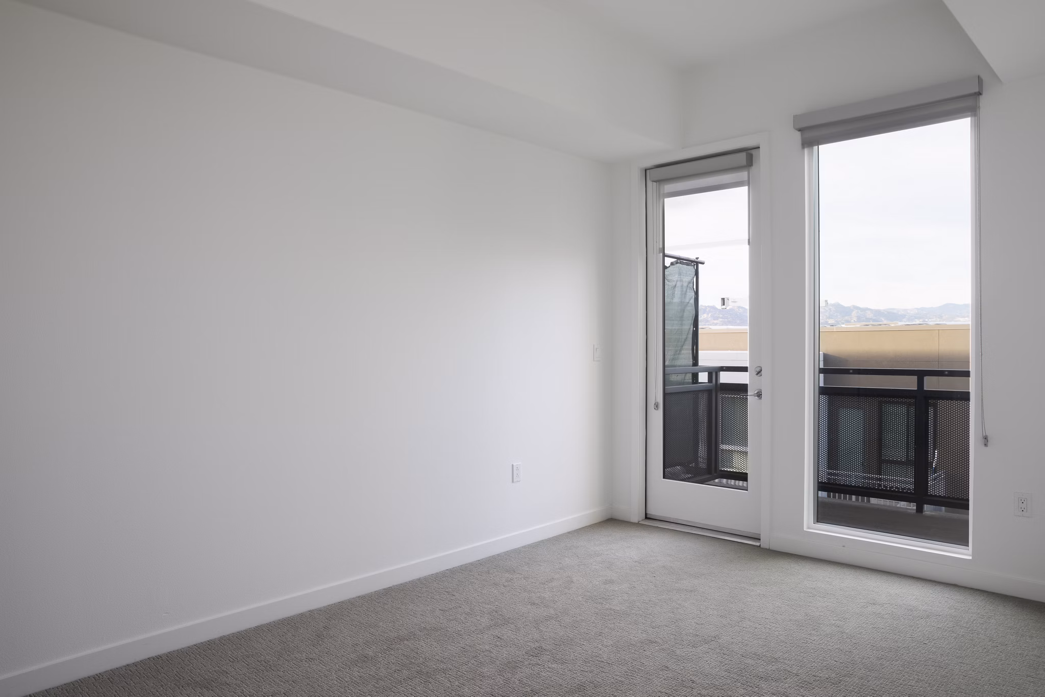 Cozy bedroom with modern furnishings at Vert Apartments in Greystar's luxury apartment collection