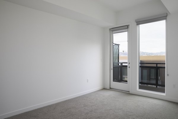 Cozy bedroom with modern furnishings at Vert Apartments in Greystar's luxury apartment collection