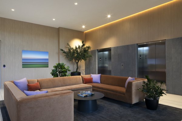 Modern clubhouse at Vert Apartments featuring luxury seating areas and vibrant decor, perfect for social gatherings and community events