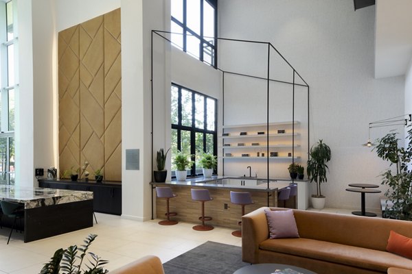 Elegant clubhouse with modern seating and lush decor at Vert Apartments, Greystar luxury community